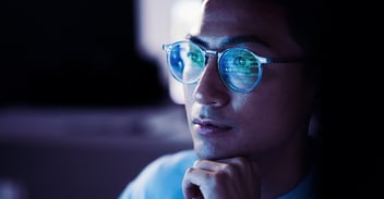 computer screen reflected in the glasses of a cloud security defender